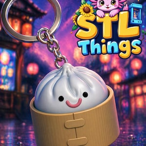May include: A keychain featuring a 3D-rendered dumpling in a bamboo steamer. The dumpling has a smiling face. The keychain is attached to a silver ring and chain. The background includes the text "STL Things" and a cartoon axolotl.