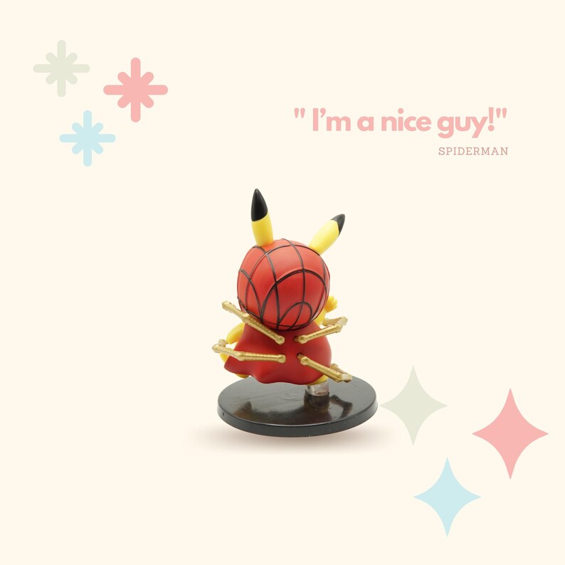 May include: A yellow Pikachu figurine wearing a red and blue Spiderman costume with gold web-like accents. The figurine is standing on a black base. The text "I'm a nice guy!" is written in pink above the figurine. The text "SPIDERMAN" is written in black below the figurine.