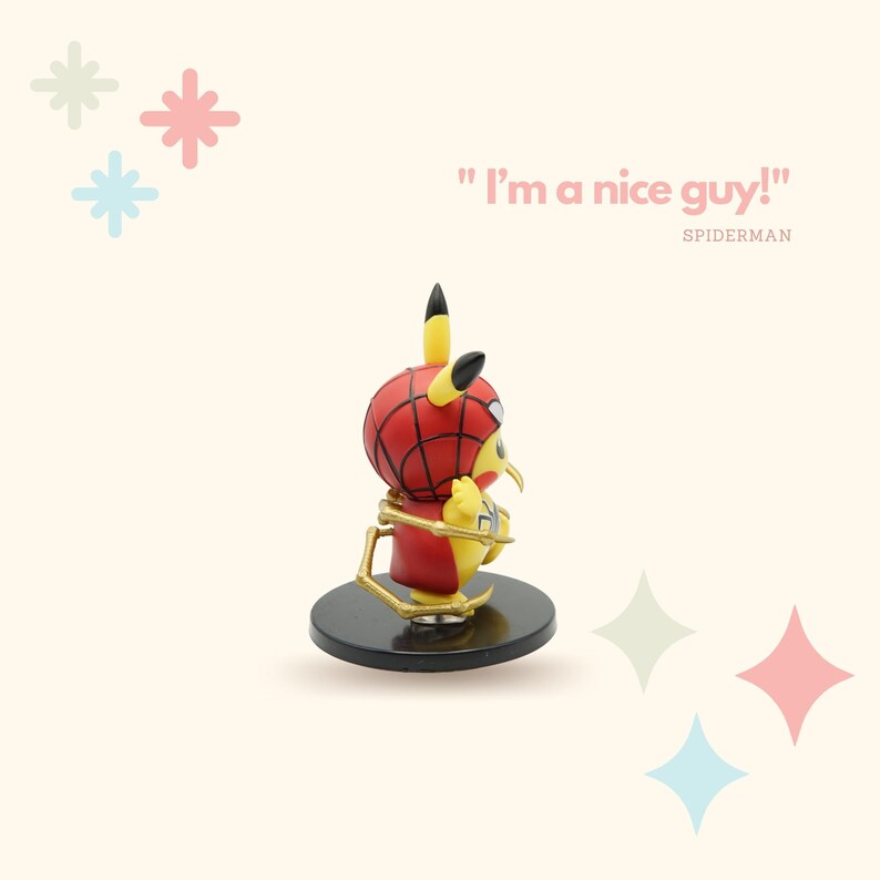 May include: A yellow Pikachu figurine wearing a red and blue Spiderman costume with gold web accents. The figurine is standing on a black base and the text "I'm a nice guy!" is written in pink above the figurine. The text "SPIDERMAN" is written in black below the figurine.