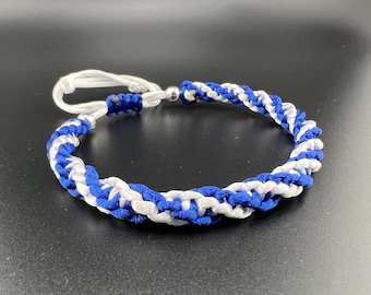 May include: A white and blue braided bracelet with a silver clasp.
