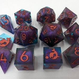 May include: A set of 10 polyhedral dice with a purple and blue swirl pattern and red numbers. The dice are shaped like a d4, d6, d8, d10, d%, d12, and d20. Each die has a unique symbol on one side, including a fish, a crab, a jellyfish, a starfish, a seahorse, a turtle, and a dolphin.