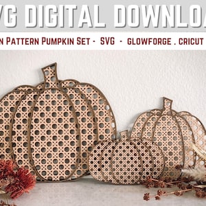 May include: Set of three wooden pumpkins with a rattan pattern. The pumpkins are different sizes and are arranged in a row. The pumpkins are a light brown color and have a natural wood finish.