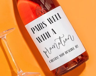 May include: A bottle of rose wine with a white label that says "Pairs well with a promotion. Cheers! You deserve it!"