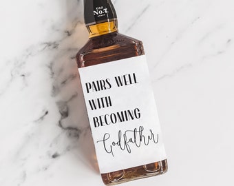 May include: A brown glass bottle with a white label that says "Pairs well with becoming Godfather".