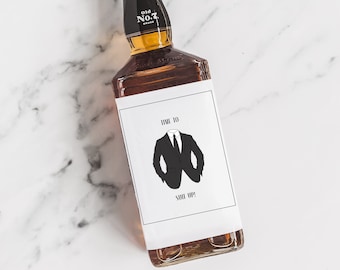 May include: A brown glass bottle with a white label that says "Time to Suit Up!" and has a black and white illustration of a suit. The bottle is labeled "Old No. 7 Brand".