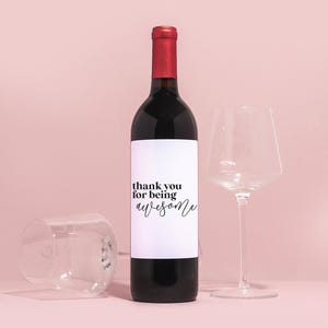 a bottle of wine next to a wine glass