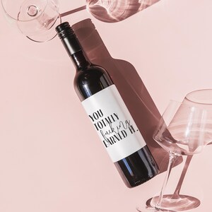 a bottle of wine sitting next to a wine glass