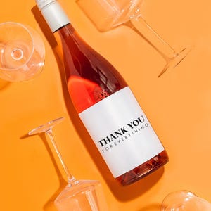 a bottle of wine sitting next to some wine glasses