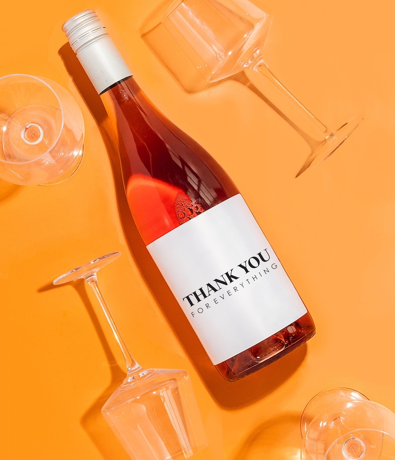 a bottle of wine sitting next to some wine glasses