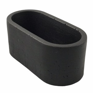 May include: A black oval-shaped concrete planter. The planter has a rough, textured surface.