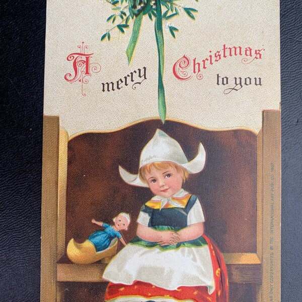 Antique Dutch Girl Doll Christmas Signed Ellen Clapsaddle German Vintage Postcard Child Bench Clogs Doll Mistletoe Embossed