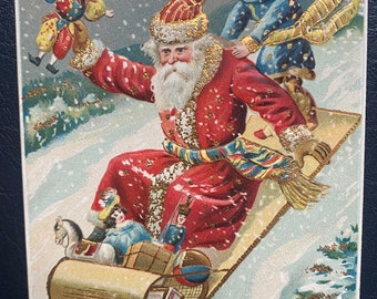 Vintage Rare German Christmas Postcard Belsnickle Santa Claus Sledding w/ Child Kid Toys Gold Gilded Textured Embossed Antique Stamp Sent 65