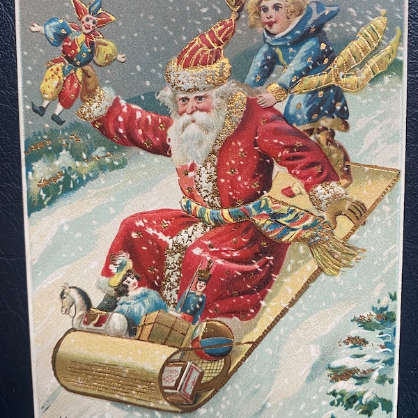 Vintage Rare German Christmas Postcard Belsnickle Santa Claus Sledding w/ Child Kid Toys Gold Gilded Textured Embossed Antique Stamp Sent 65