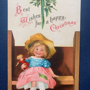 VGC Antique Girl Doll Christmas Signed Ellen Clapsaddle German Vintage Postcard Child on Bench Doll Mistletoe Best Wishes Happy Embossed