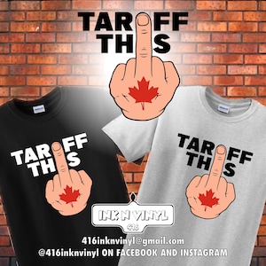 May include: Two t-shirts featuring a graphic of a middle finger with a Canadian flag on it. The text "TAROFF THIS" is printed on the shirts. The shirts are black and grey.