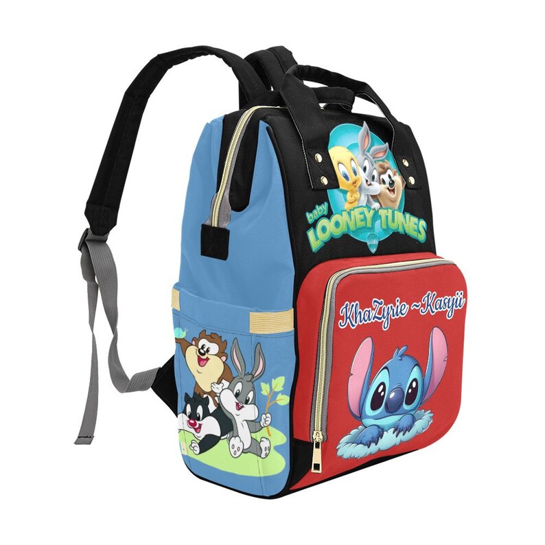 May include: A multi-colored backpack featuring a black top, light blue sides, and a red front pocket. The bag displays Baby Looney Tunes characters, the text "Baby Looney Tunes," the name "KhaZyrie~Kasyii," and a graphic of the character Stitch.