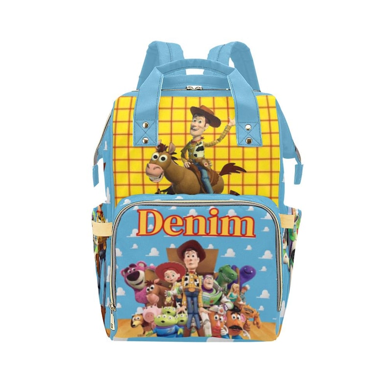 May include: A blue and yellow backpack featuring characters from the Toy Story movie. The backpack has a large front pocket with the word "Denim" printed on it. The top section has a yellow plaid pattern with a cartoon image of Woody riding a horse.
