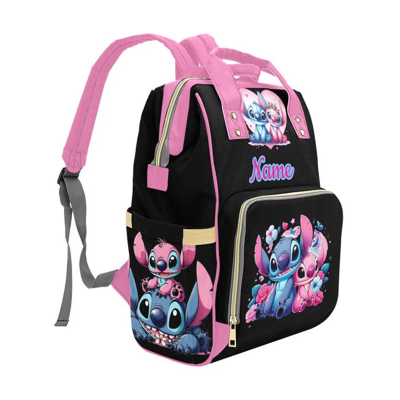 May include: A black backpack with pink trim and straps featuring cartoon characters Stitch and Angel. The front pocket and side display colorful illustrations of the characters with floral accents. The word Name is printed in blue and pink on the front.