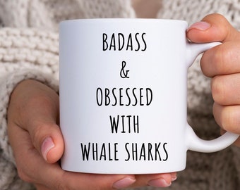 May include: White ceramic mug with black text that reads "Badass & Obsessed with Whale Sharks".
