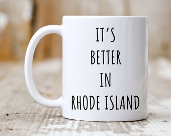 May include: White ceramic mug with black text that reads "It's Better in Rhode Island".