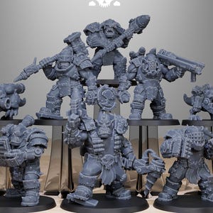 May include: A set of nine grey plastic miniature figures of orcs, goblins, and other fantasy creatures. The figures are posed in various fighting stances and are holding weapons such as axes, swords, and guns. The figures are all standing on round bases.