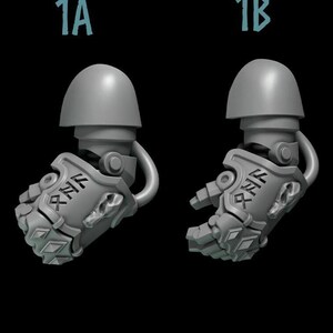 May include: Two gray plastic miniature figures of a robot arm with a fist, one with a closed fist and the other with an open hand. The figures have a rune symbol on the arm and a skull on the fist.