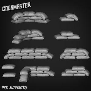 May include: A collection of gray sandbag models in various arrangements. The sandbags are stacked to create defensive barriers. The image includes the text "GOONMASTER" and "PRE-SUPPORTED".