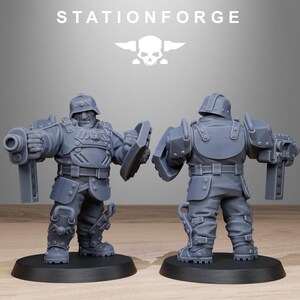 May include: A gray plastic miniature figure of a soldier wearing a helmet and armor, holding a gun and a shield. The figure is standing on a round base.