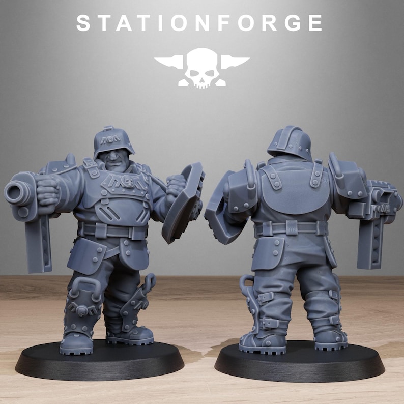 May include: A gray plastic miniature figure of a soldier wearing a helmet and armor, holding a gun and a shield. The figure is standing on a round base.