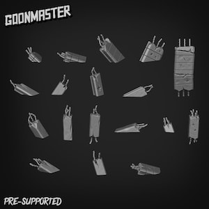 May include: A collection of pre-supported, grayscale 3D-printed objects, possibly for miniature gaming or model building. The objects vary in shape, including rectangular and angled forms, with wire-like details. The text "GOONMASTER" and "PRE-SUPPORTED" are visible.