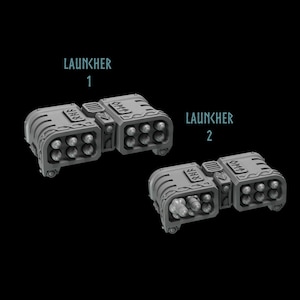 May include: Two gray plastic model rocket launchers with the text "LAUNCHER 1" and "LAUNCHER 2" above each. Each launcher has a row of six cylindrical missile pods.