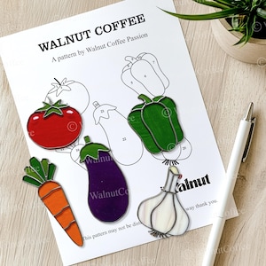 May include: A printable pattern for stained glass art featuring a tomato, carrot, eggplant, garlic, and bell pepper. The pattern is titled "Walnut Coffee" and includes numbered sections for coloring.