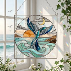 May include: Stained glass panel depicting a whale tail emerging from turquoise waves, with a setting sun and a crescent moon. The design uses blue, green, orange, and brown, framed in a square with a hanging chain.