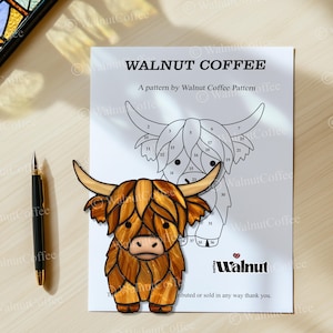 May include: A black and white line art pattern of a Highland cow with numbered sections for stained glass crafting. The pattern is titled "Walnut Coffee" and includes the text "A pattern by Walnut Coffee Pattern".