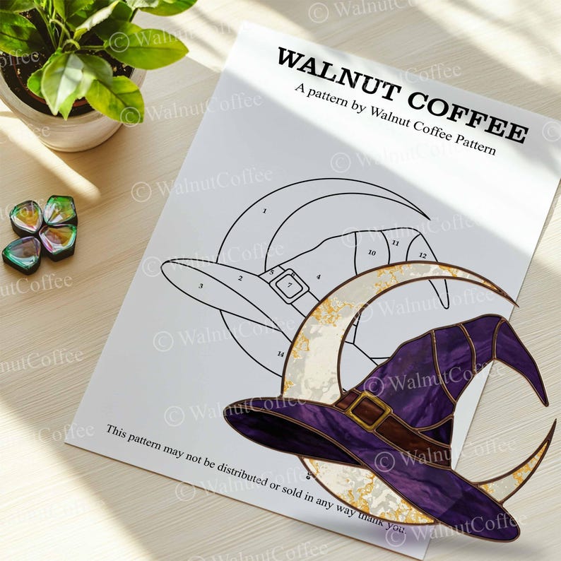 May include: A printed pattern by Walnut Coffee featuring a witch hat and crescent moon design. The hat is purple with a brown band and buckle. The text "WALNUT COFFEE" is at the top of the page.