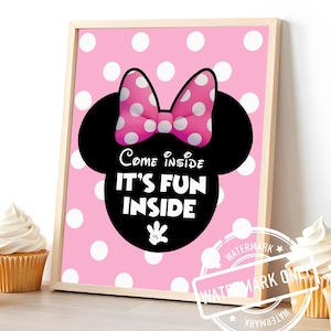 May include: A framed pink polka dot print with a Minnie Mouse design. The print features a black silhouette of Minnie's head, a pink bow with white polka dots, and the text "Come inside, it's fun inside."