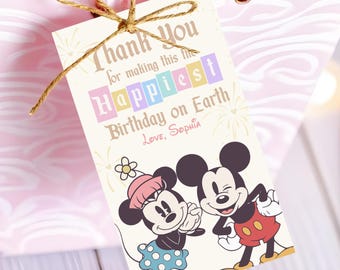 May include: A pink gift bag with a tag tied with twine. The tag features Mickey and Minnie Mouse and the text "Thank You for making this the Happiest Birthday on Earth. Love, Sophia."