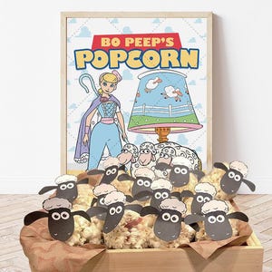 May include: A party favor box filled with popcorn and decorated with black and white sheep characters. The box is labeled "Bo Peep's Popcorn".