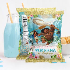 May include: A colourful party favour bag with a Moana theme. The bag features a cartoon image of Maui, a Polynesian demigod, holding a fish hook. The bag also has the text "The Ocean is Calling! Moana 3rd Birthday".