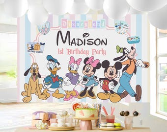 May include: A colorful backdrop for a 1st birthday party featuring Disney characters like Mickey Mouse, Minnie Mouse, Donald Duck, and Goofy. The backdrop includes the name "Madison" and the word "Disneyland".