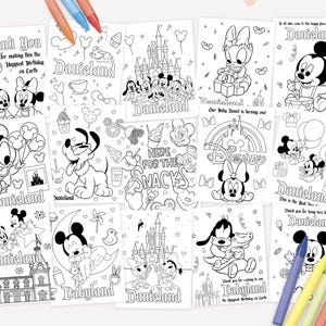 May include: A collection of black and white coloring pages featuring cartoon characters, castles, and snacks with text including Danieland and Babyland. The pages are arranged in a grid with colorful crayons placed at the top and bottom corners.