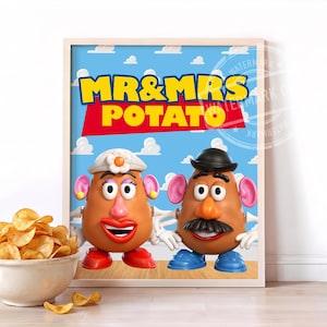 May include: A framed poster featuring Mr. and Mrs. Potato Head characters against a blue sky with white clouds. The text reads MR & MRS POTATO in yellow and white letters on a red background. A white bowl filled with potato chips sits in the foreground.