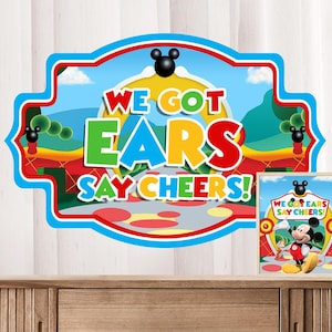 May include: A colorful sign with Mickey Mouse ears and the text "We Got Ears Say Cheers!"  The sign is decorated with red, yellow, green, and blue colors.  The background is a cartoon image of a park with a blue sky.