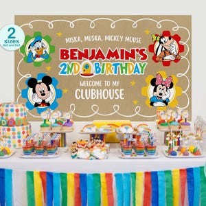 May include: A rectangular party backdrop featuring a tan background with white doodle borders and cartoon characters including Donald Duck, Goofy, Mickey Mouse, and Minnie Mouse. Text reads: MISKA, MUSKA, MICKEY MOUSE BENJAMIN'S 2ND BIRTHDAY WELCOME TO MY CLUBHOUSE.