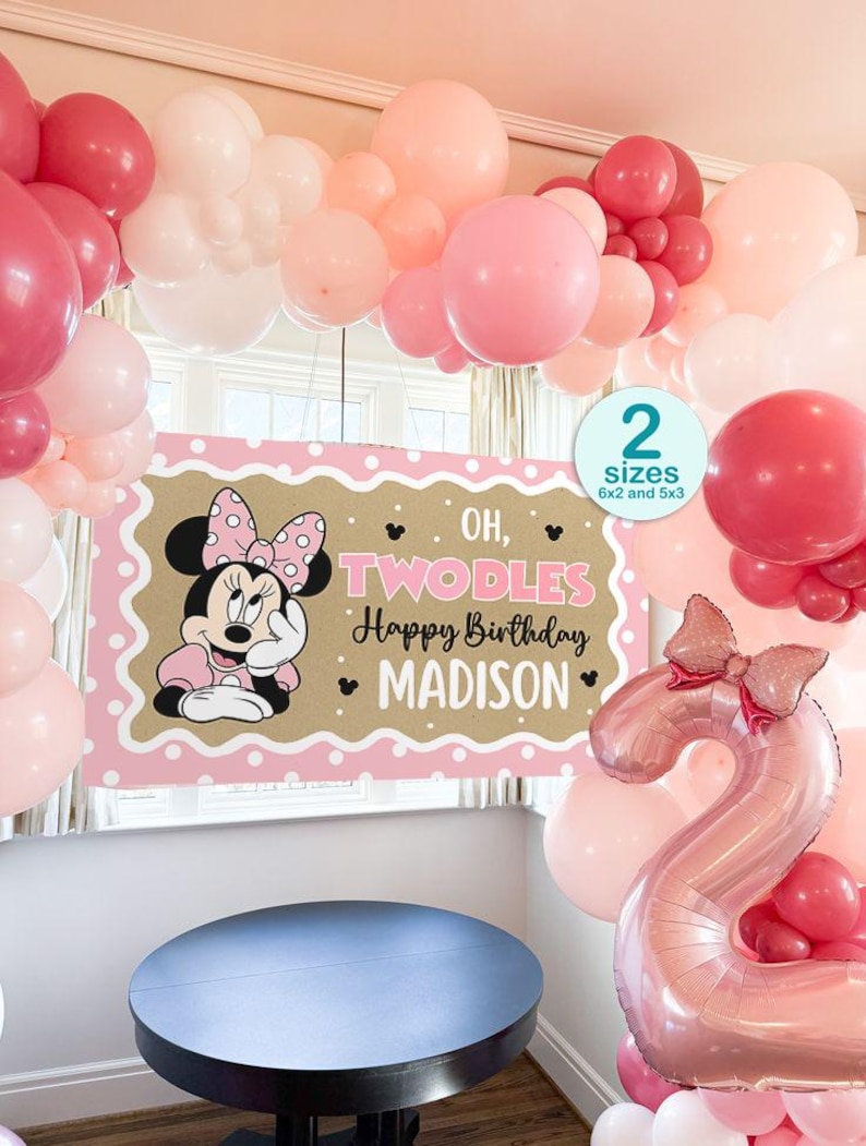 May include: A festive birthday party scene with pink, white, and red balloons. A banner features Minnie Mouse and the text "Oh, Twodles Happy Birthday Madison." A large number 2 balloon is also present.