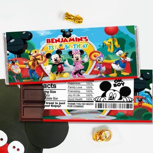 May include: A rectangular chocolate bar wrapper featuring Mickey Mouse, Minnie Mouse, Goofy, Pluto, Daisy, and Donald Duck. The text reads BENJAMIN'S 1ST BIRTHDAY and includes a nutrition facts label with 100% happiness, family love, and friendship.