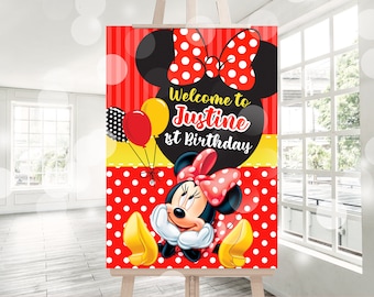 May include: Red and white polka dot background with a black silhouette of Minnie Mouse's head.  The text "Welcome to Justine's 1st Birthday" is in a yellow banner.  Minnie Mouse is wearing a red dress with white polka dots and a red bow with white polka dots.  She is holding yellow and red balloons.