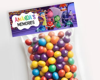 May include: A clear plastic bag filled with colorful candy. A purple and white label with the text "AMANDA'S MEMORIES" and characters from the movie Inside Out is attached to the bag.
