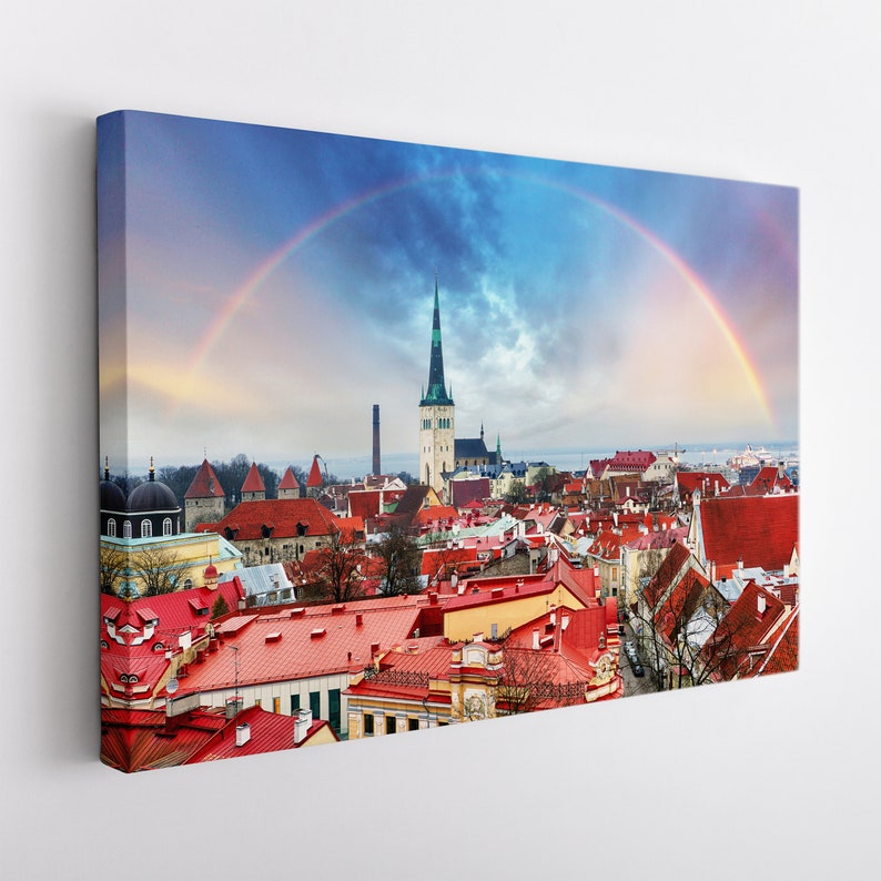 May include: A panoramic view of a city with red rooftops and a tall church steeple. A rainbow arches over the city, creating a colorful and picturesque scene.