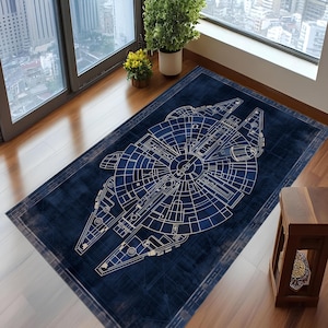May include: A rectangular navy blue rug featuring a detailed white blueprint design of a spaceship. The rug has a distressed border and is placed on a wooden floor near a window. The rug is a home decor item.